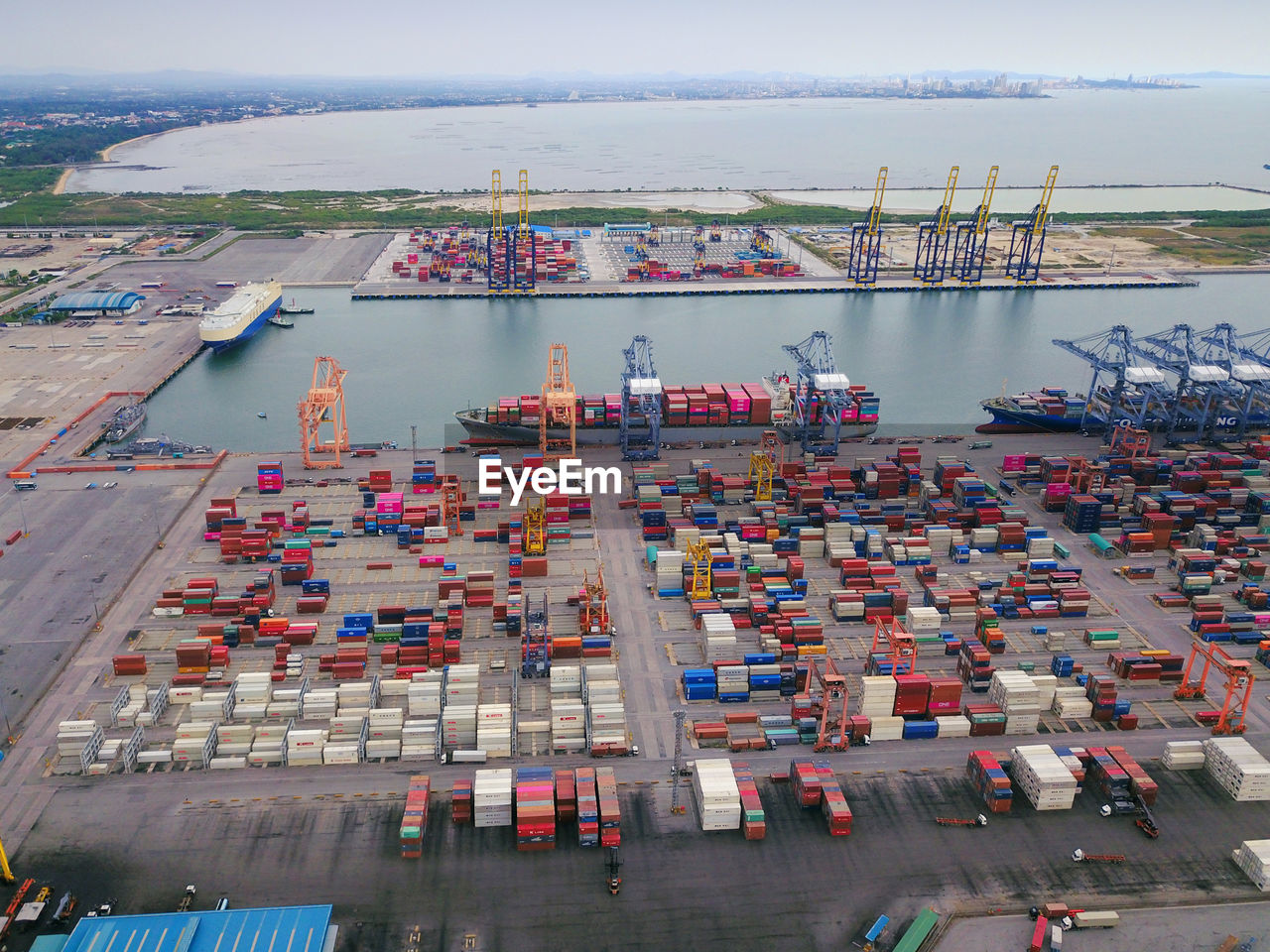 Aerial view of commercial dock by sea against sky