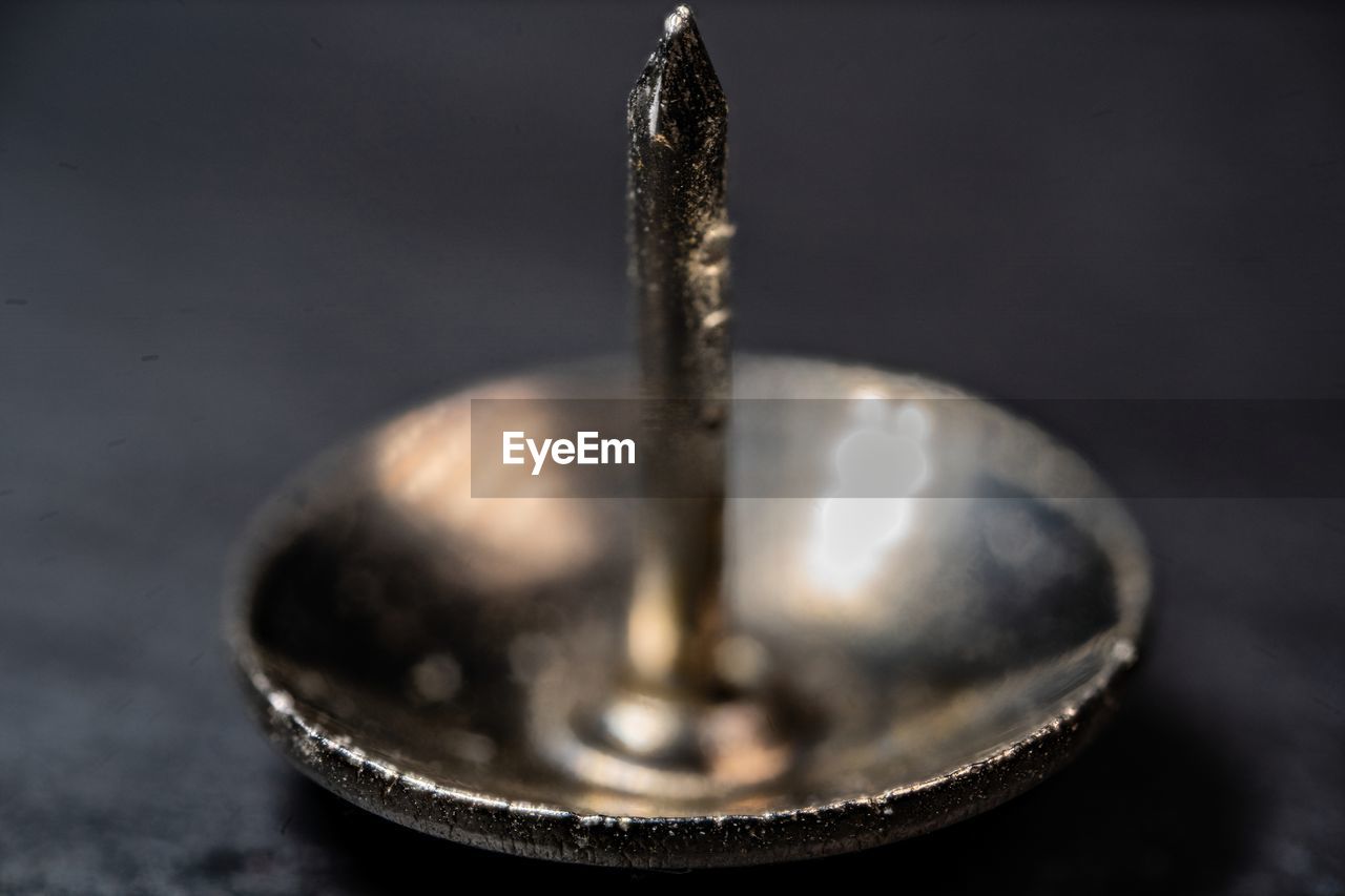 A macro photography of a metal pushpin