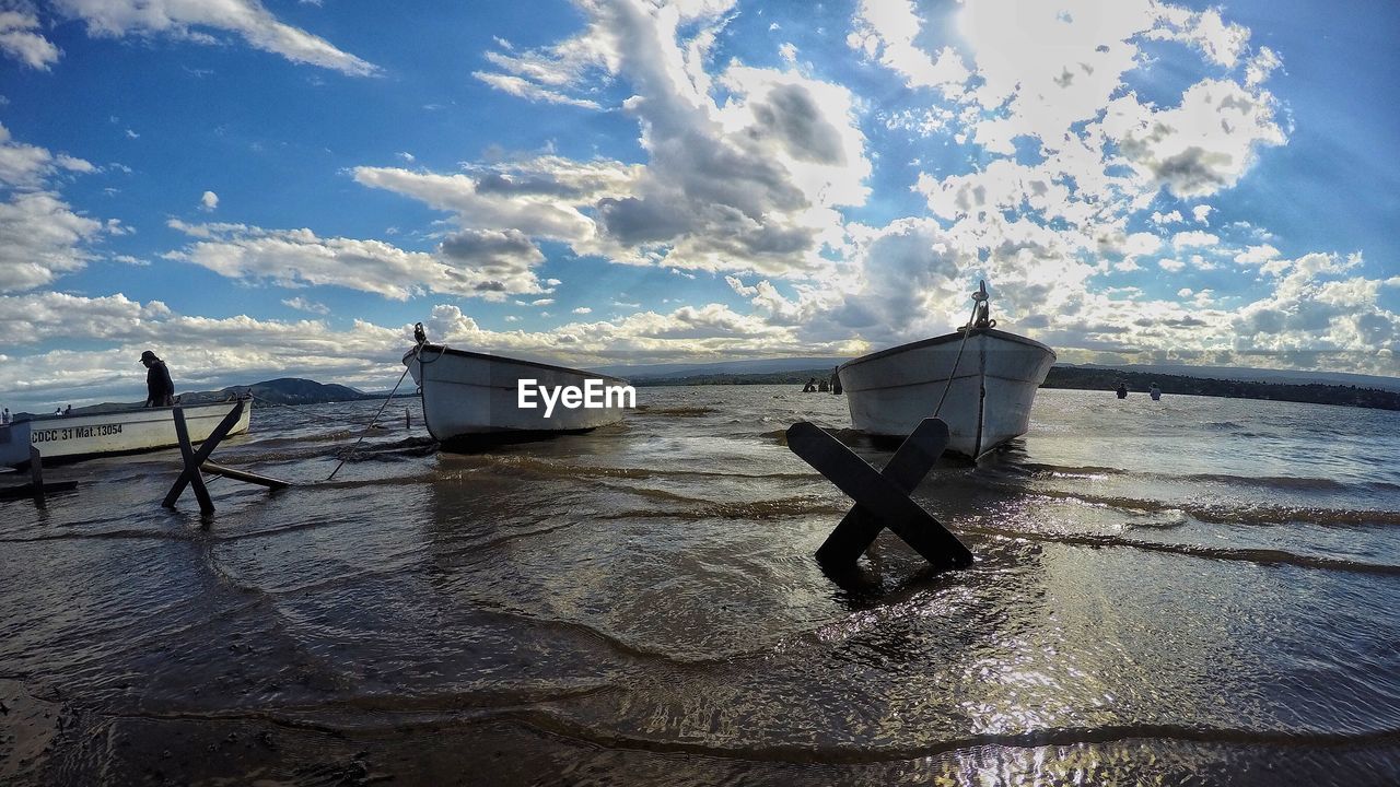 MAN ON BOAT AGAINST SEA