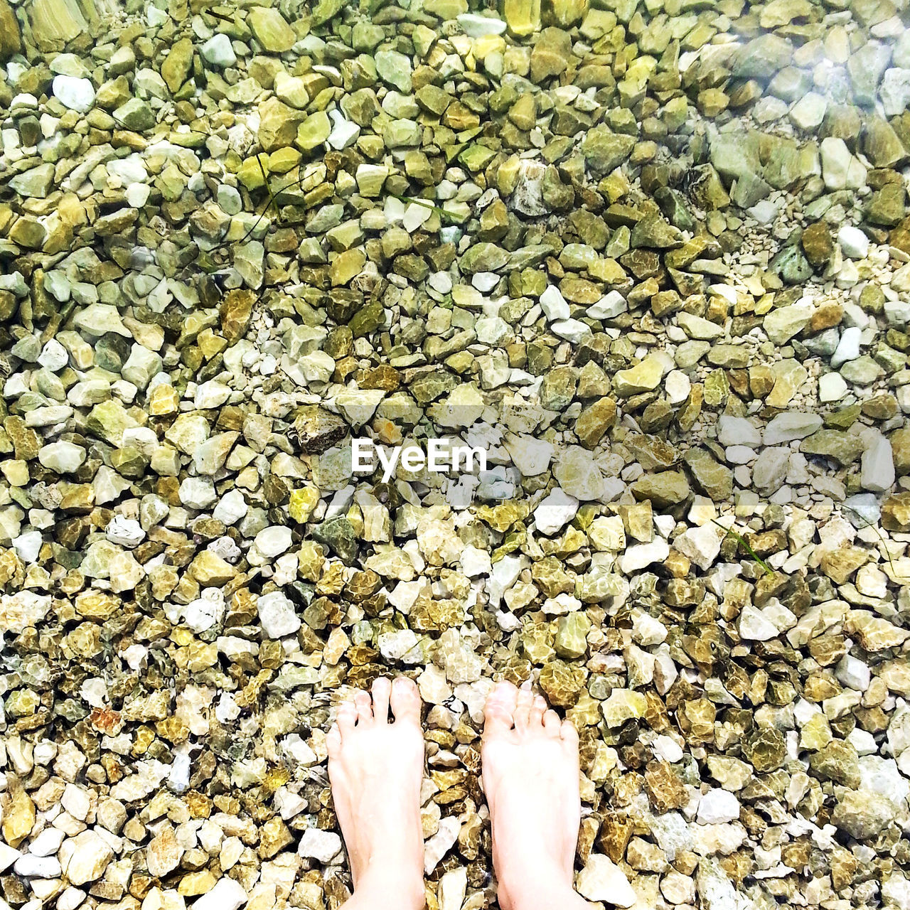 LOW SECTION OF MAN STANDING ON ROCK