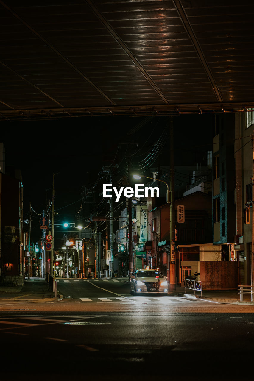 Illuminated city street at night