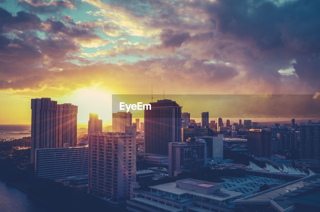 MODERN BUILDINGS AGAINST SKY DURING SUNSET