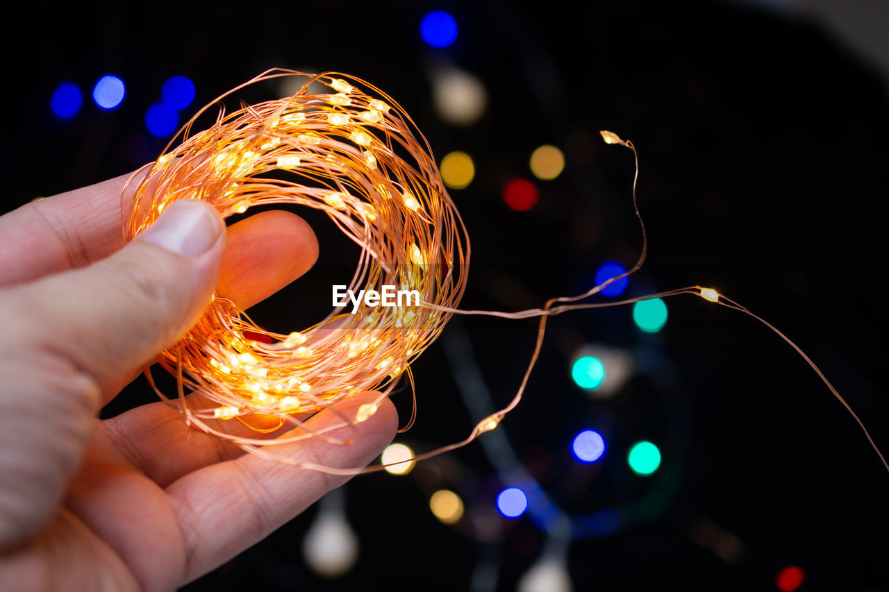 Close-up of hand holding illuminated light