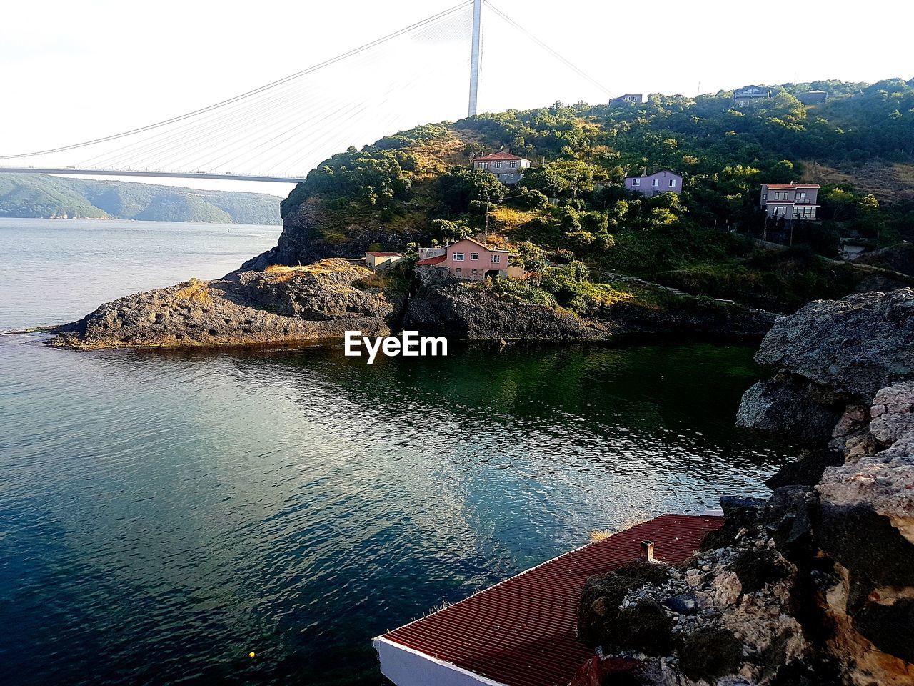 Bridge over rocks against sky