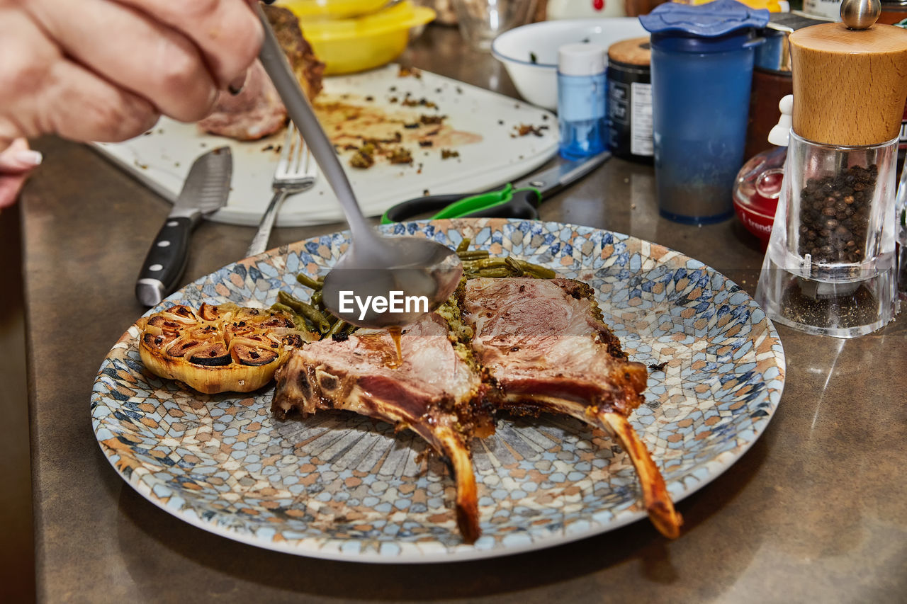 cropped hand preparing food in plate