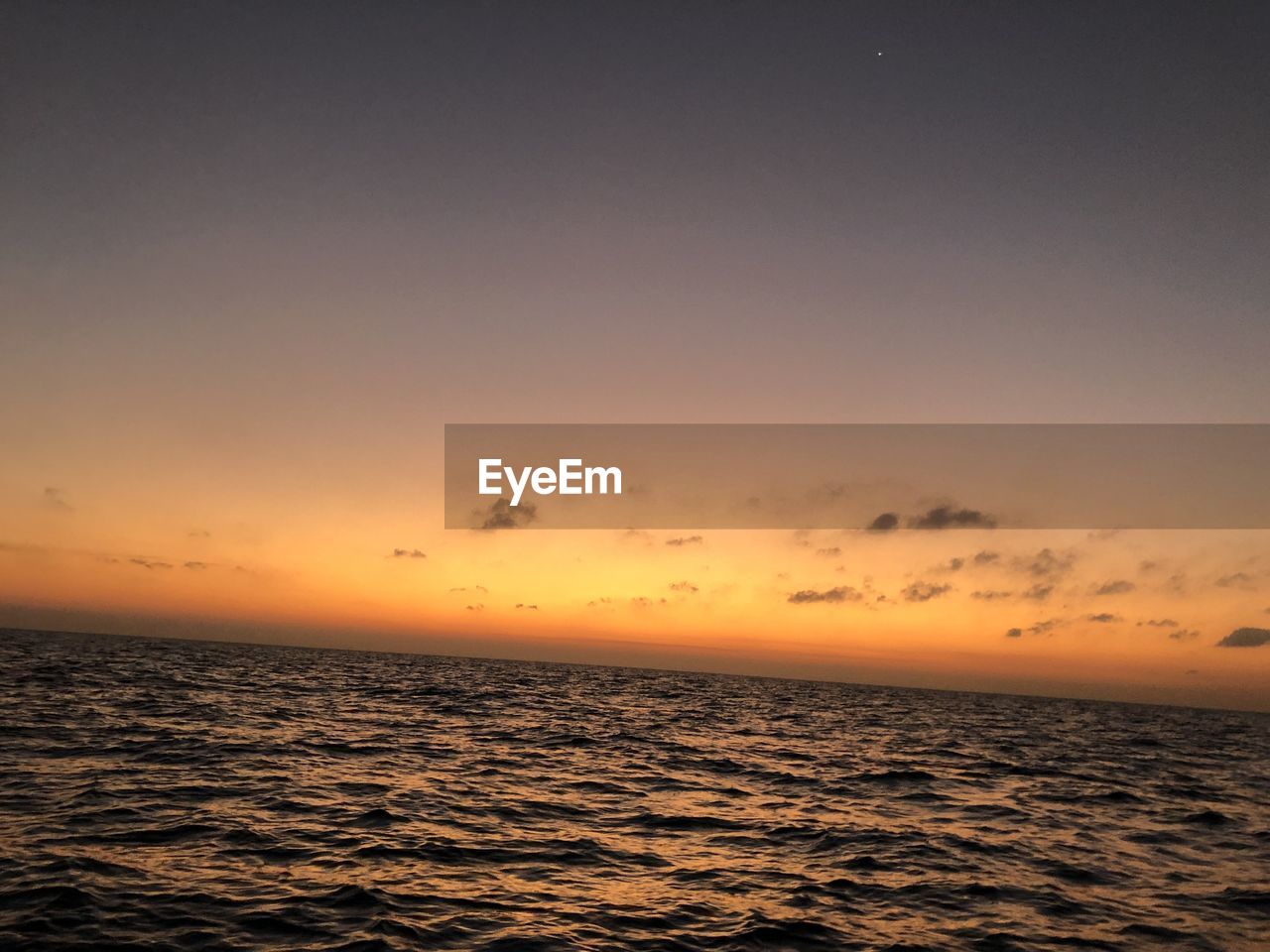 SCENIC VIEW OF SEA AGAINST ORANGE SKY