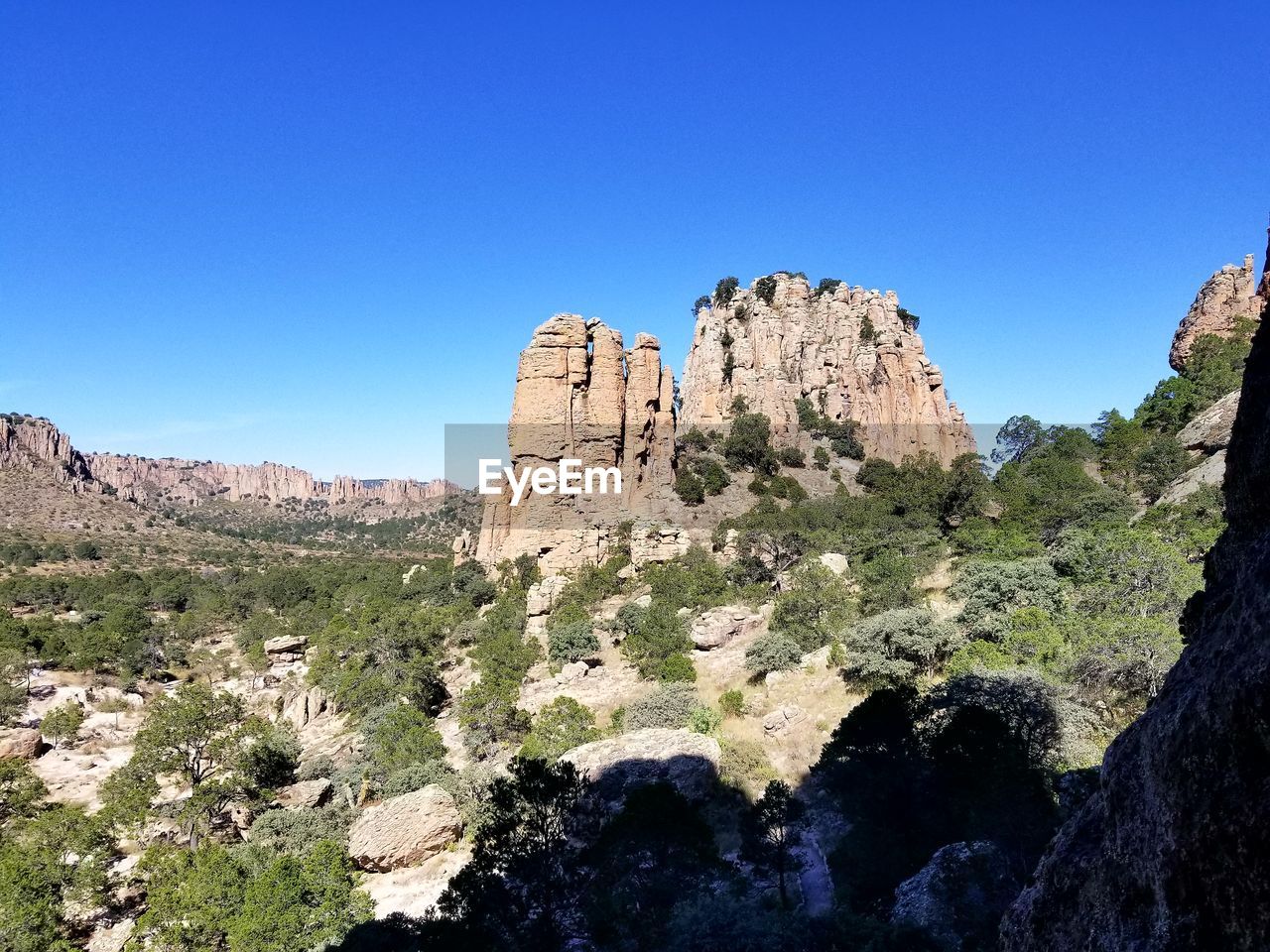 Scenic view of mountains against clear blue sky