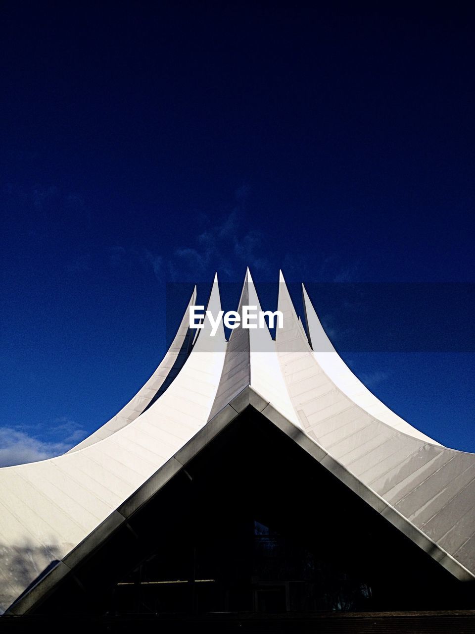 Low angle view of tempodrom against blue sky