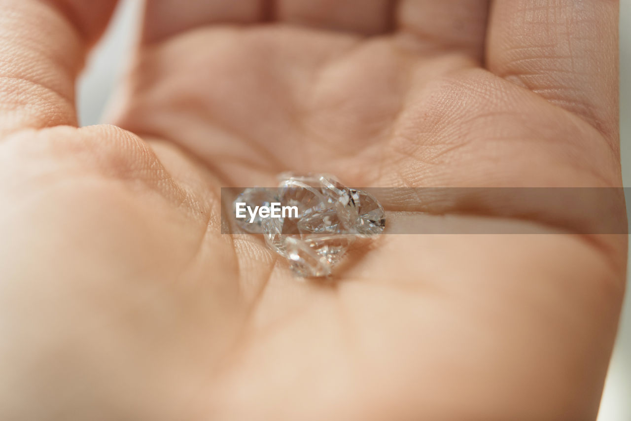 Close-up of hand holding diamonds