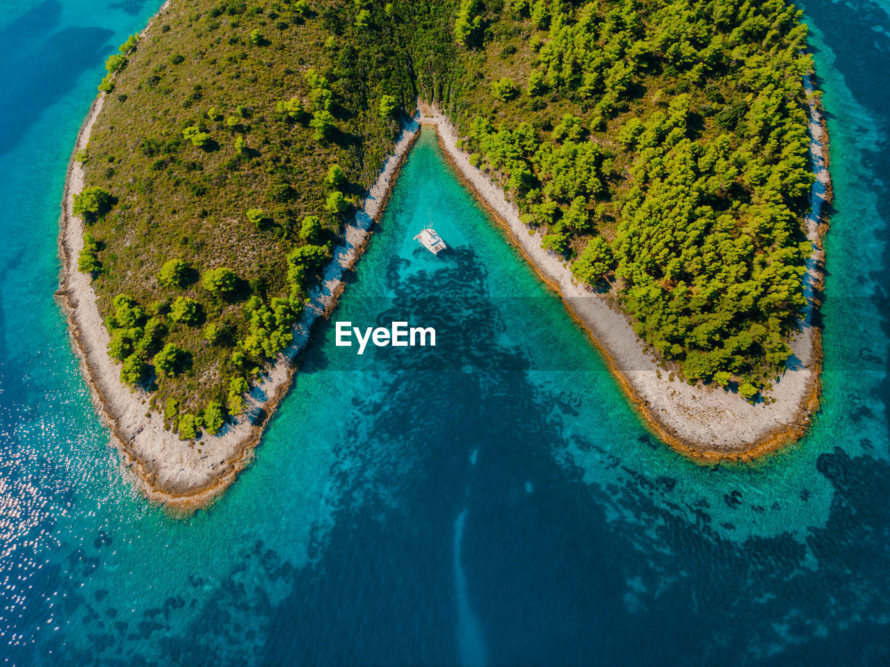 Sailing yacht catamaran anchored in a remote beautiful bay in croatia.