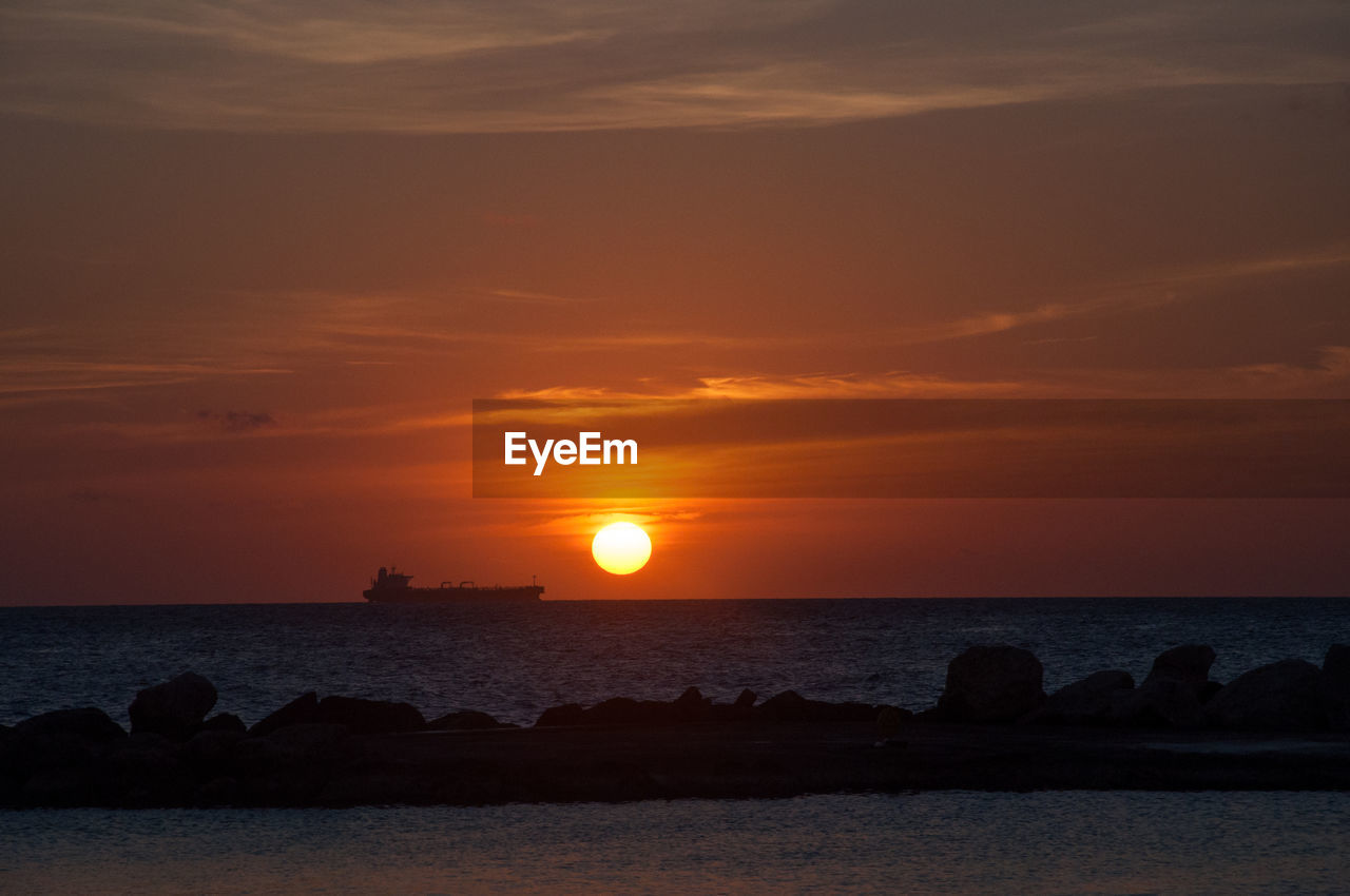 scenic view of sea at sunset