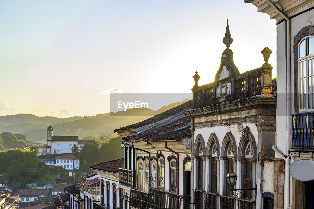 Colonial style houses facade and historic baroque church on the hills of ouro preto