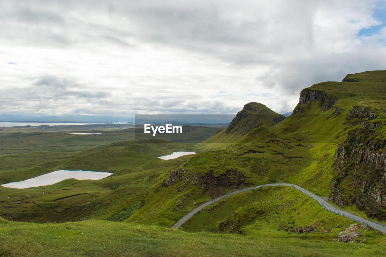 Scenic view of green landscape against sky