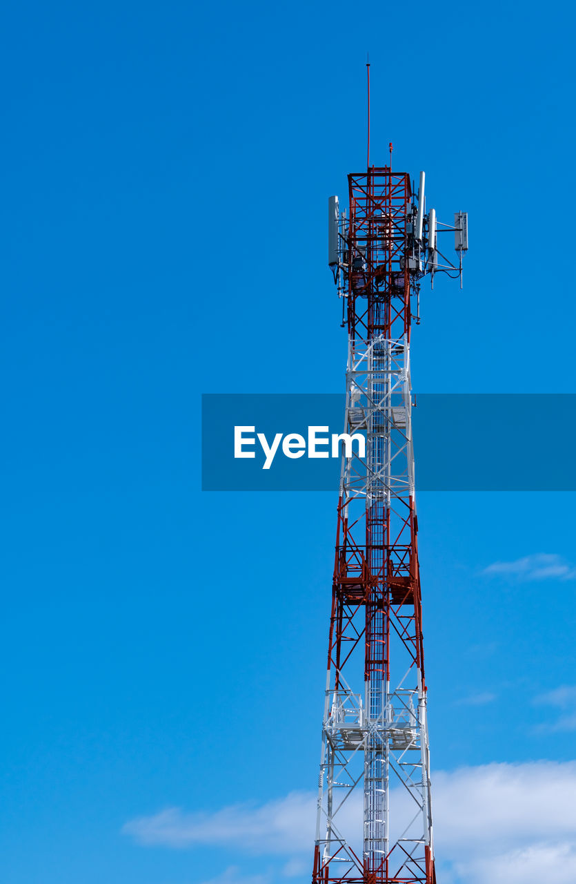 Low angle view of communications tower against blue sky. mobile or telecom 4g network.