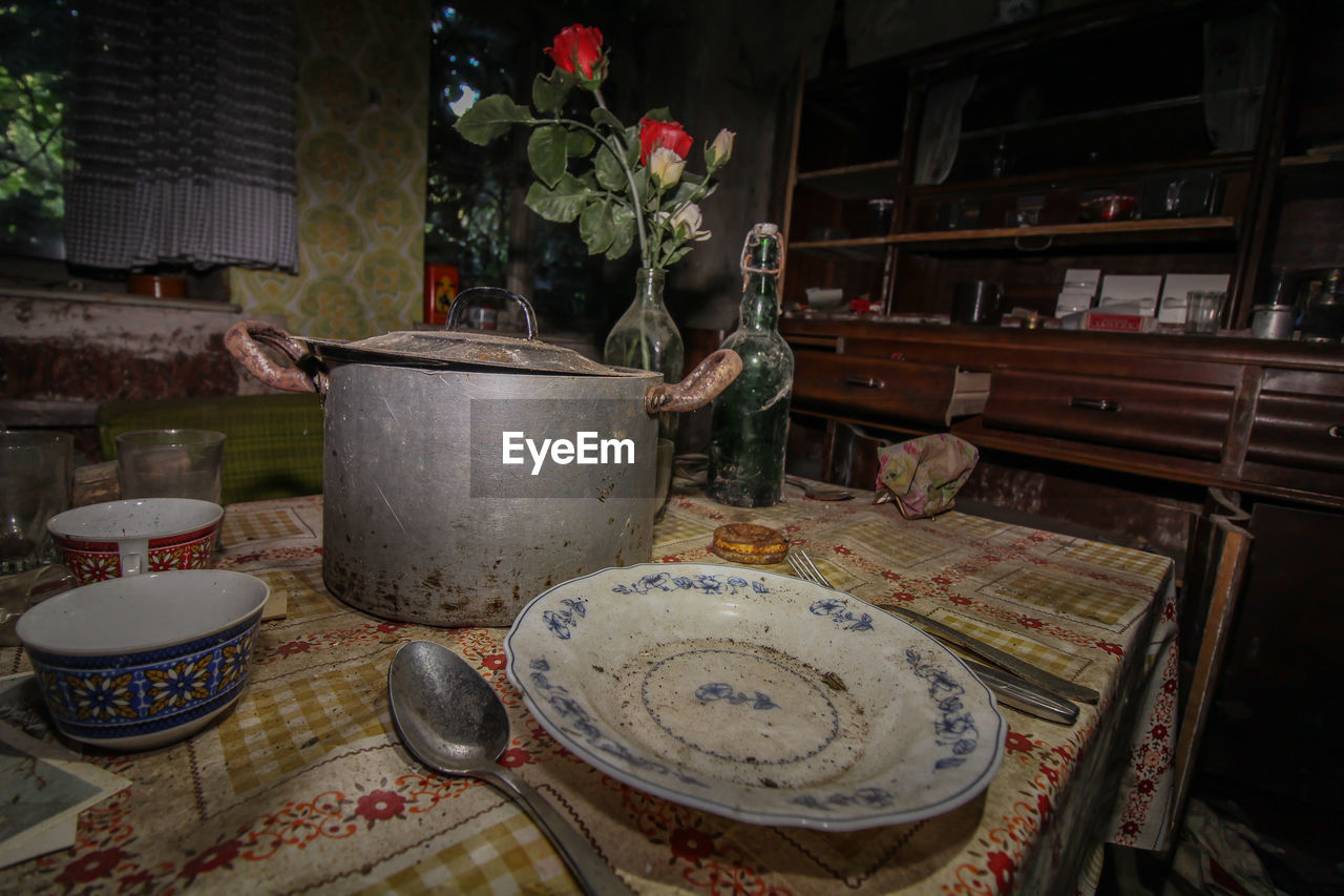 Abandoned kitchen utensils on table at home