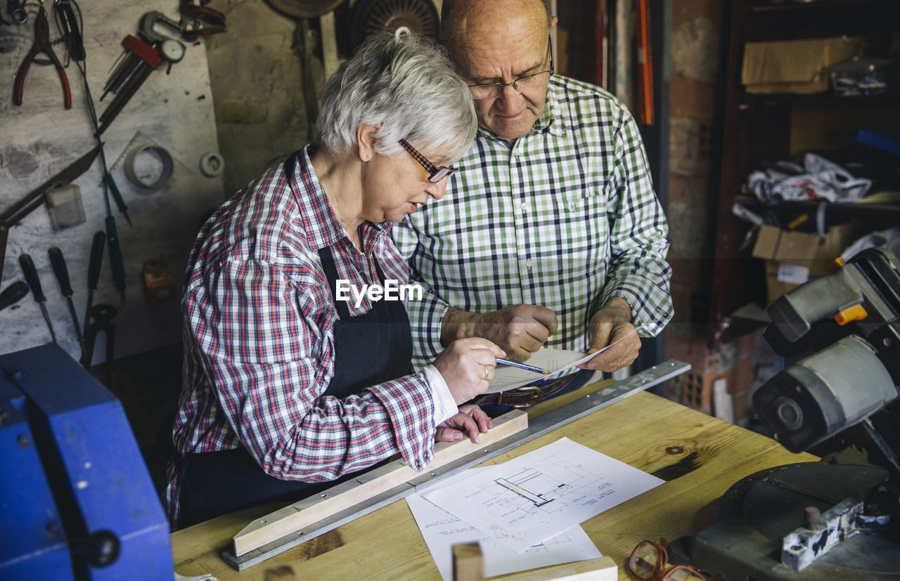 Senior couple working at workshop