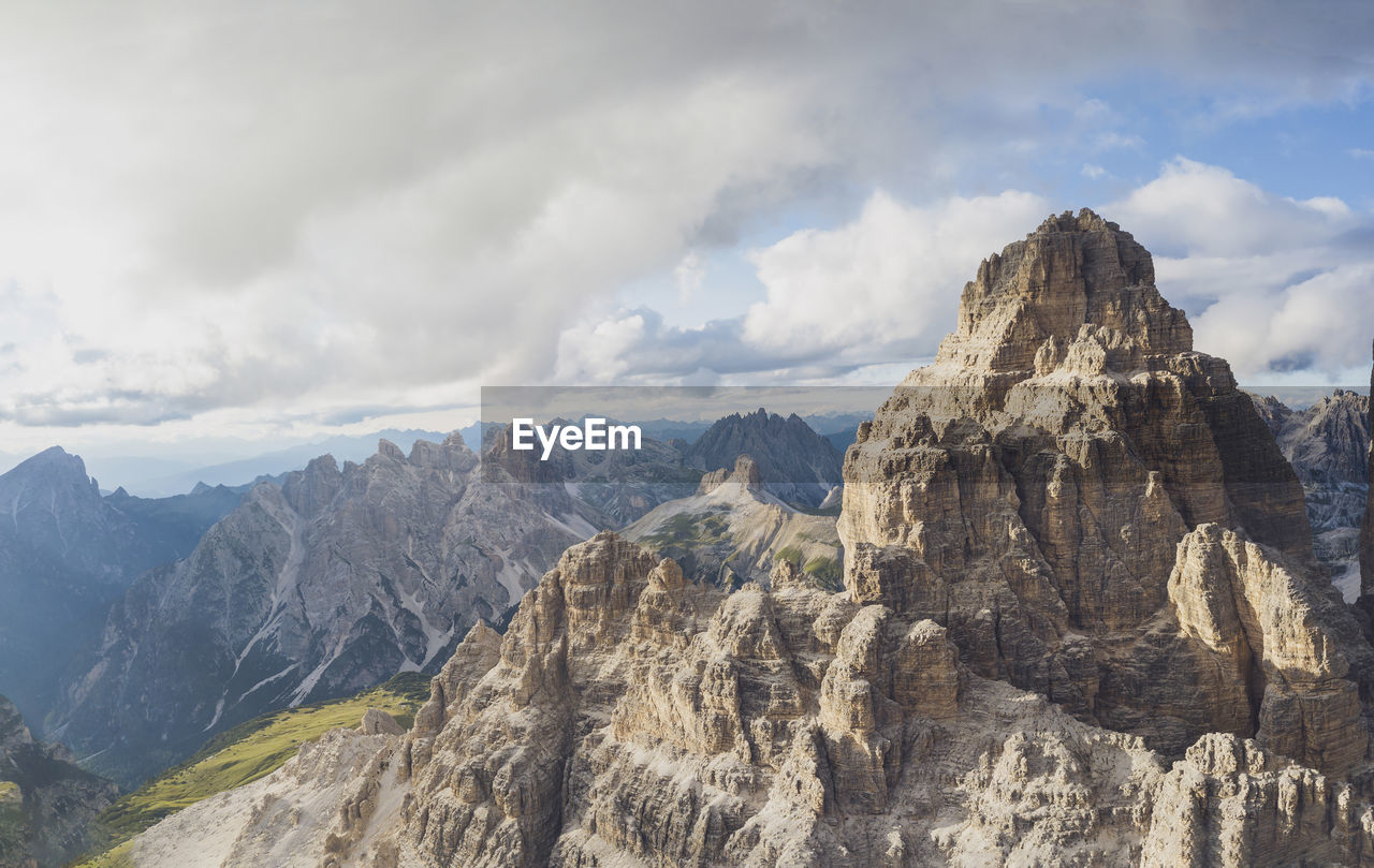 Drone view of rocky mountain peaks against sky, sesto dolomites, dolomites, alto adige, italy