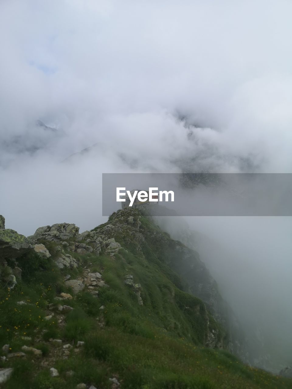 SCENIC VIEW OF FOGGY WEATHER AGAINST SKY