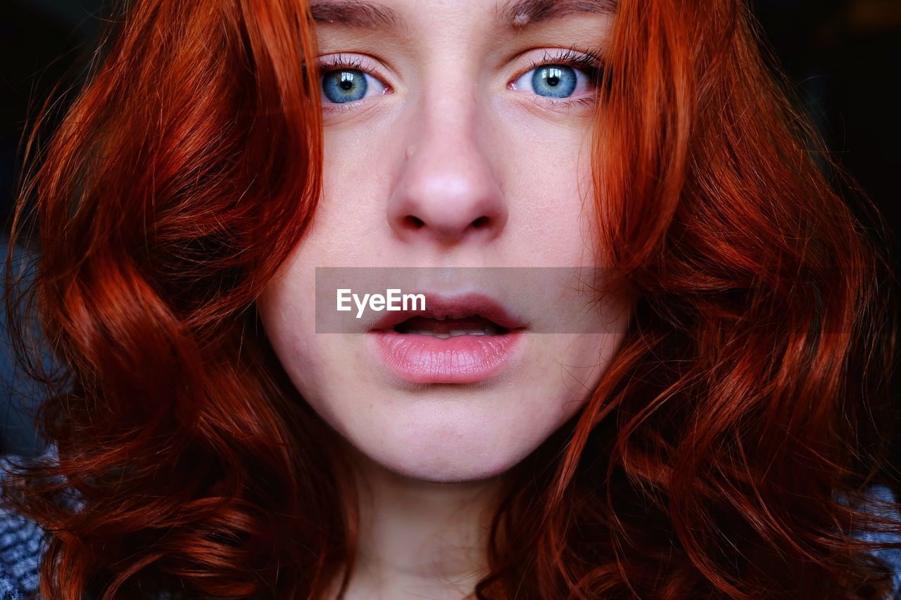 Close-up portrait of beautiful woman with redhead