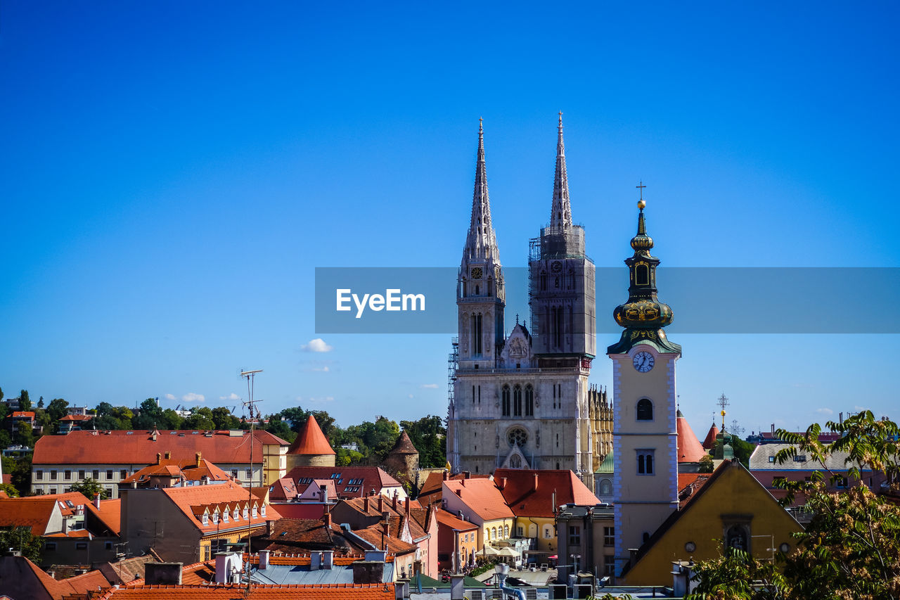 VIEW OF BUILDINGS IN CITY AGAINST BLUE SKY