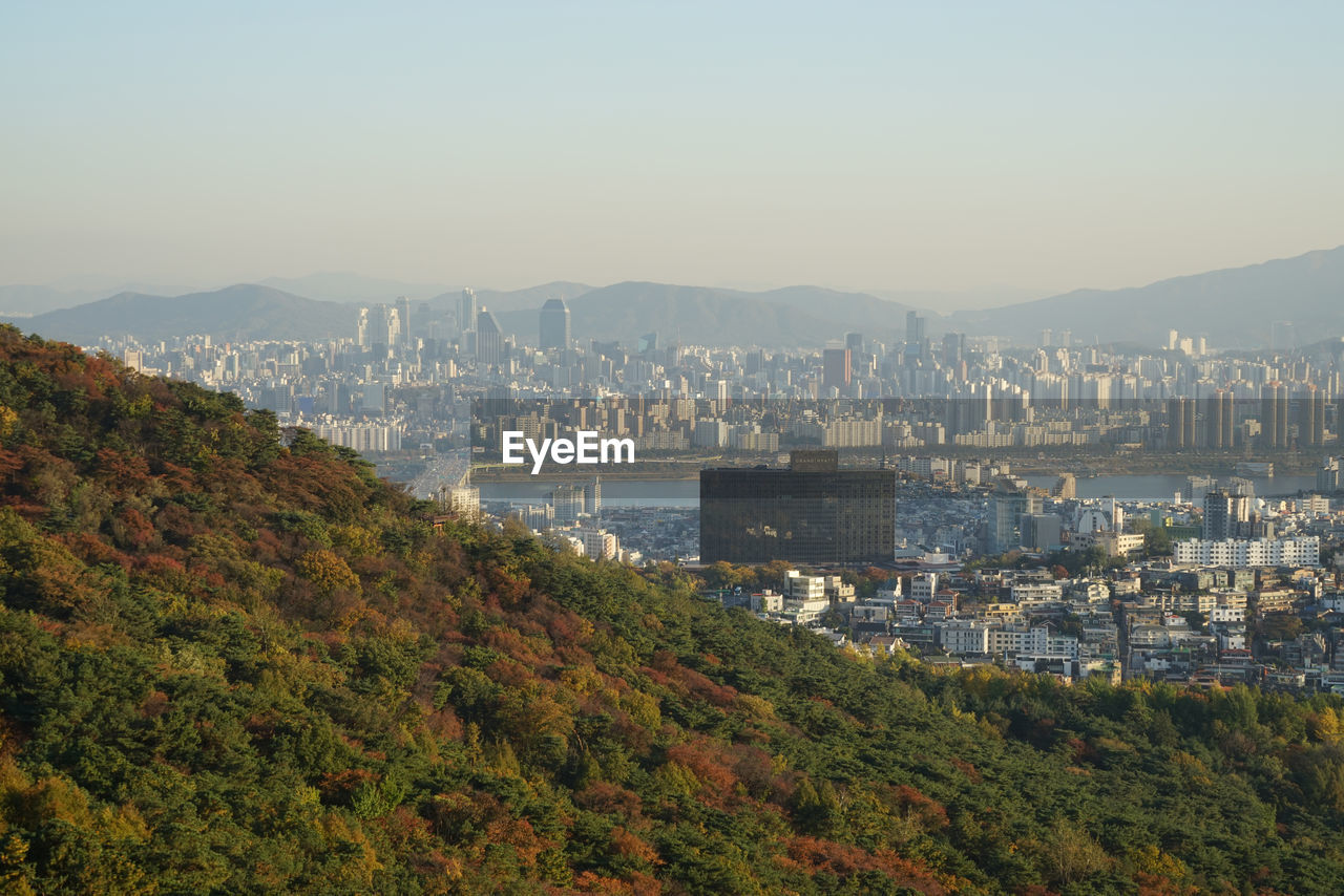 Scenic view of cityscape against sky during autumn