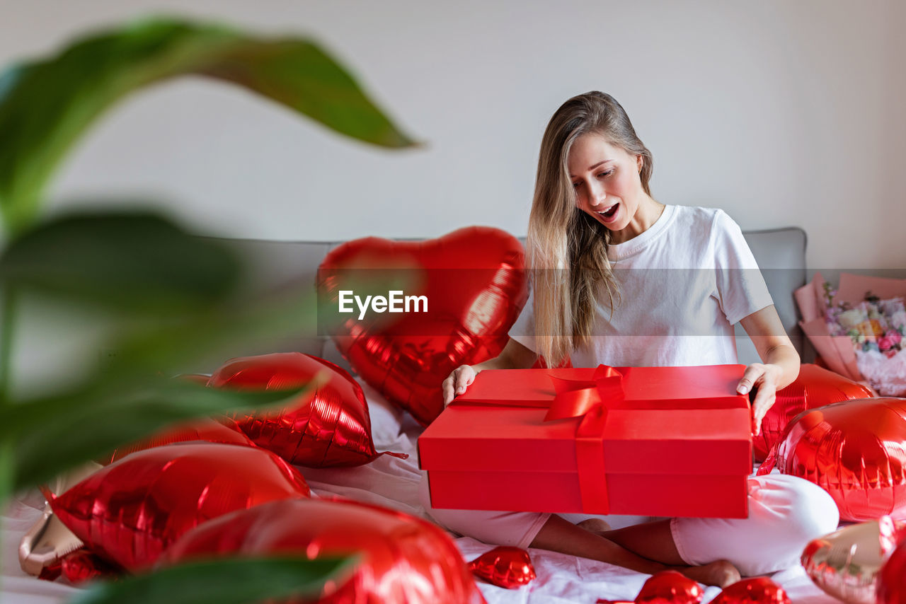 portrait of smiling young woman holding christmas tree