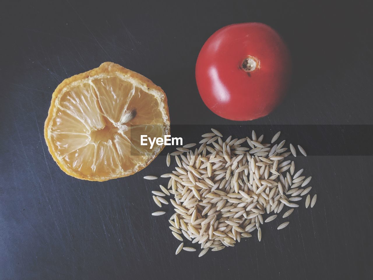 Tomato, lemon and rice on a kitchen plate