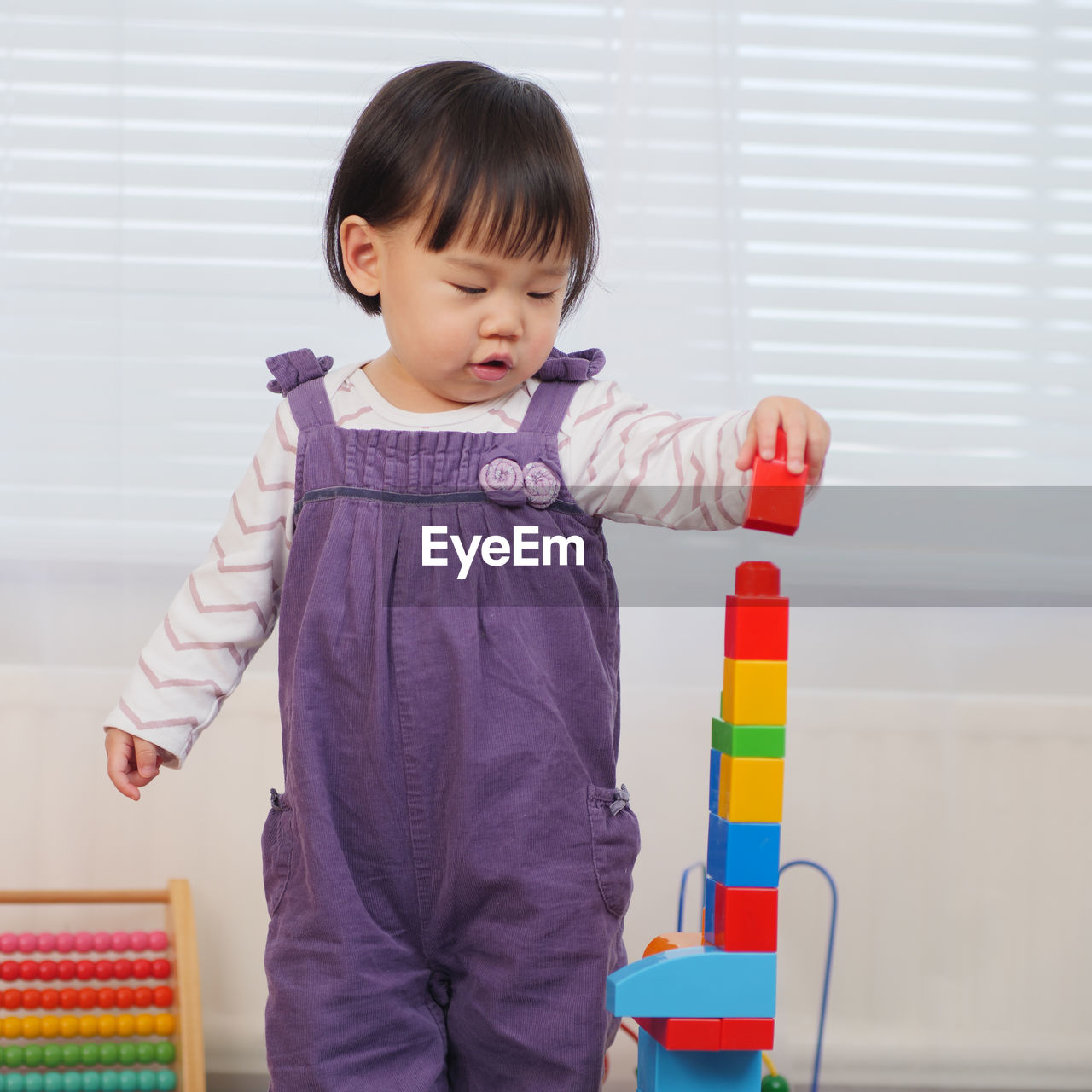 Baby girl playing with toy blocks