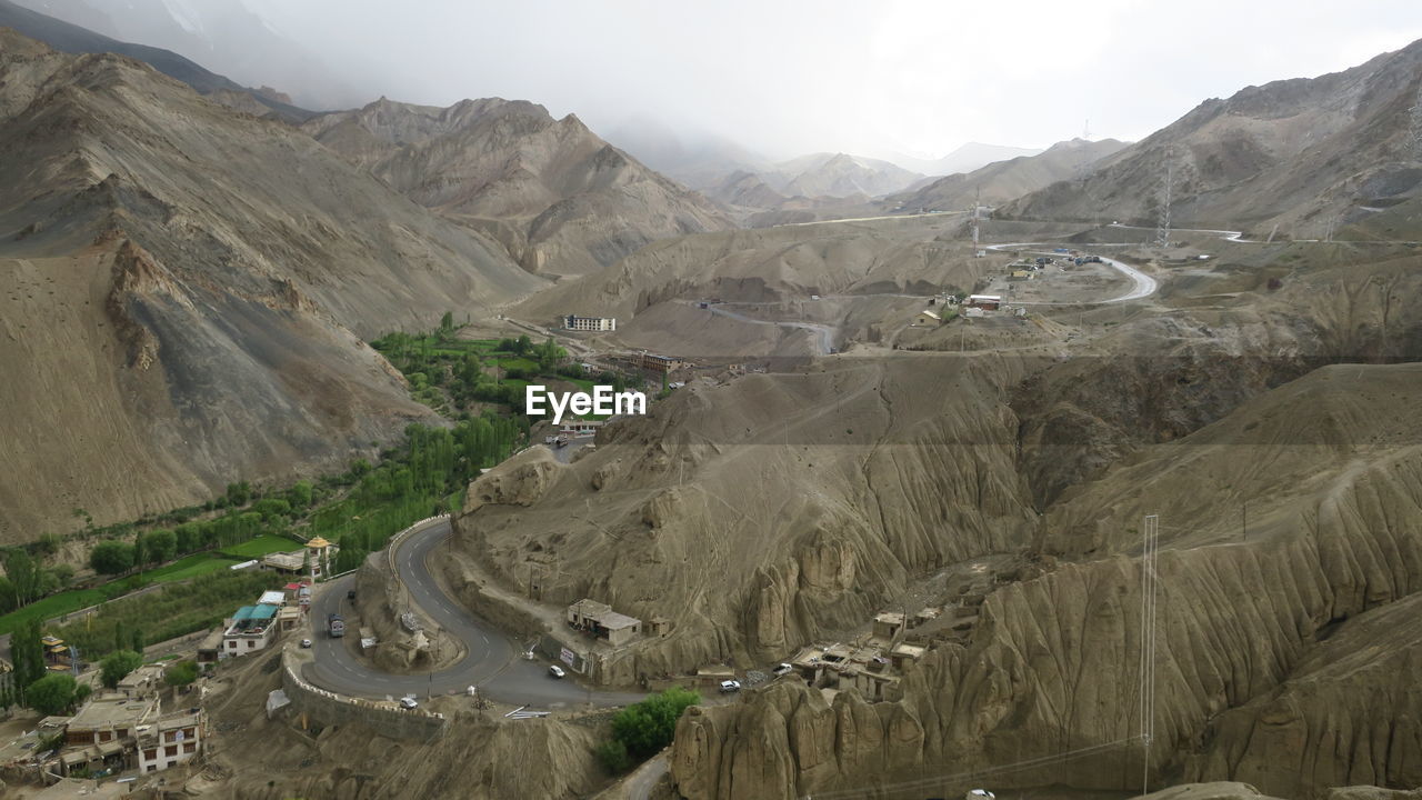 High angle view of land and mountains against sky