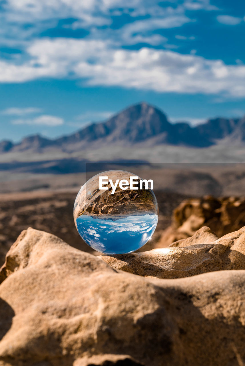 Close-up of rock on mountain against sky