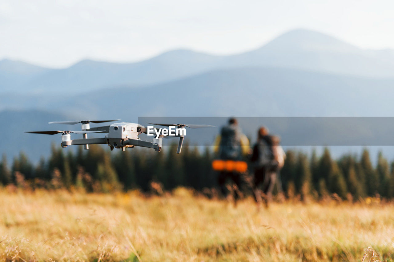 Drone on field against mountain