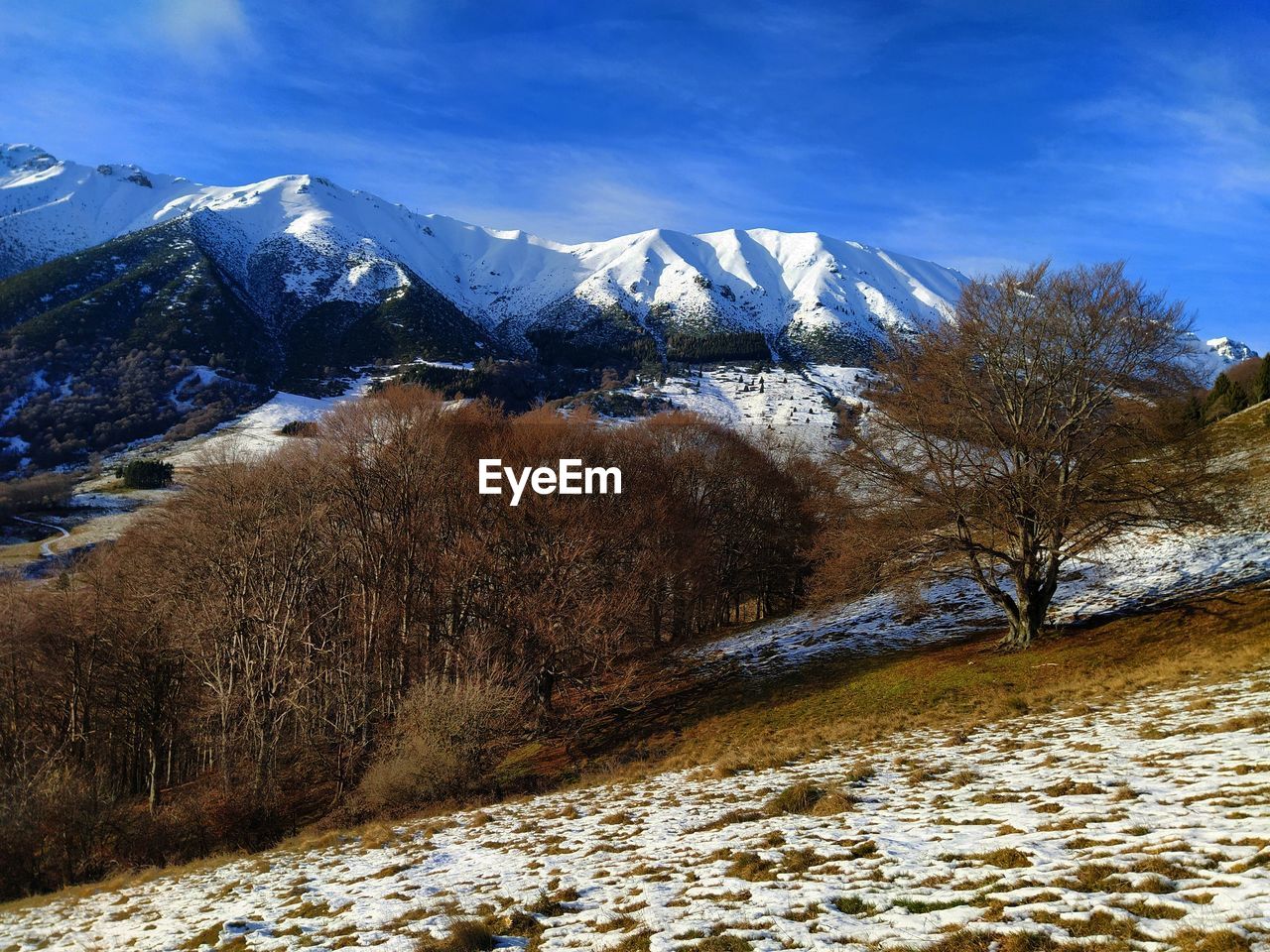 Scenic view of snowcapped mountains against sky