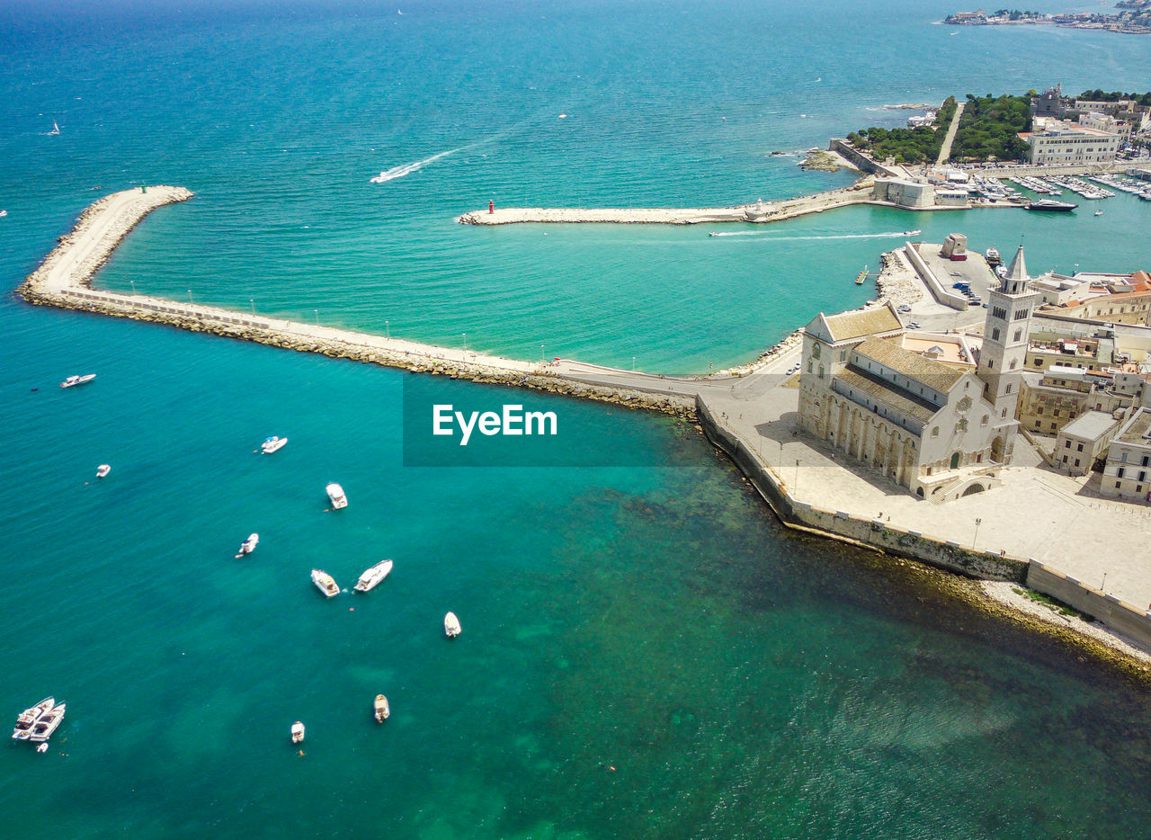 HIGH ANGLE VIEW OF SWIMMING POOL WITH SEA IN BACKGROUND