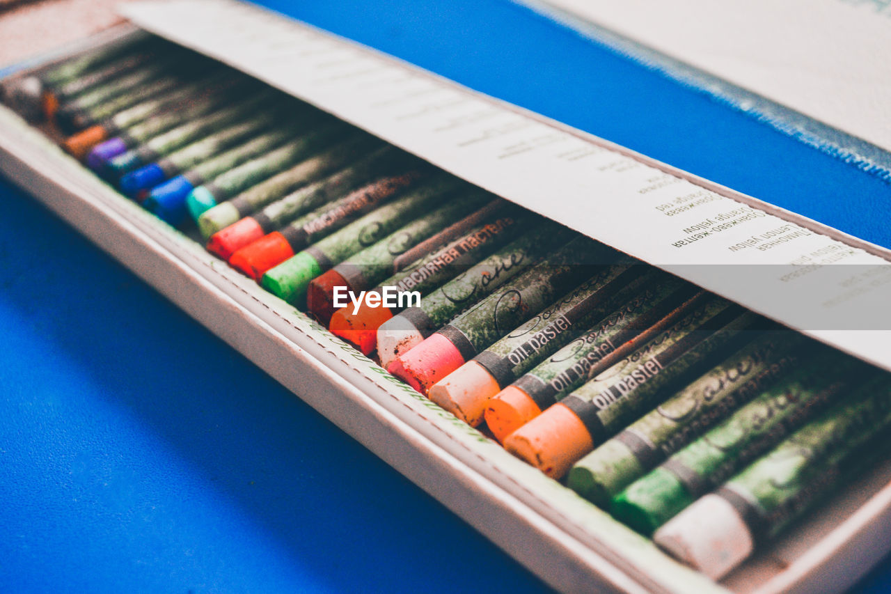CLOSE-UP OF COLORED PENCILS ON TABLE