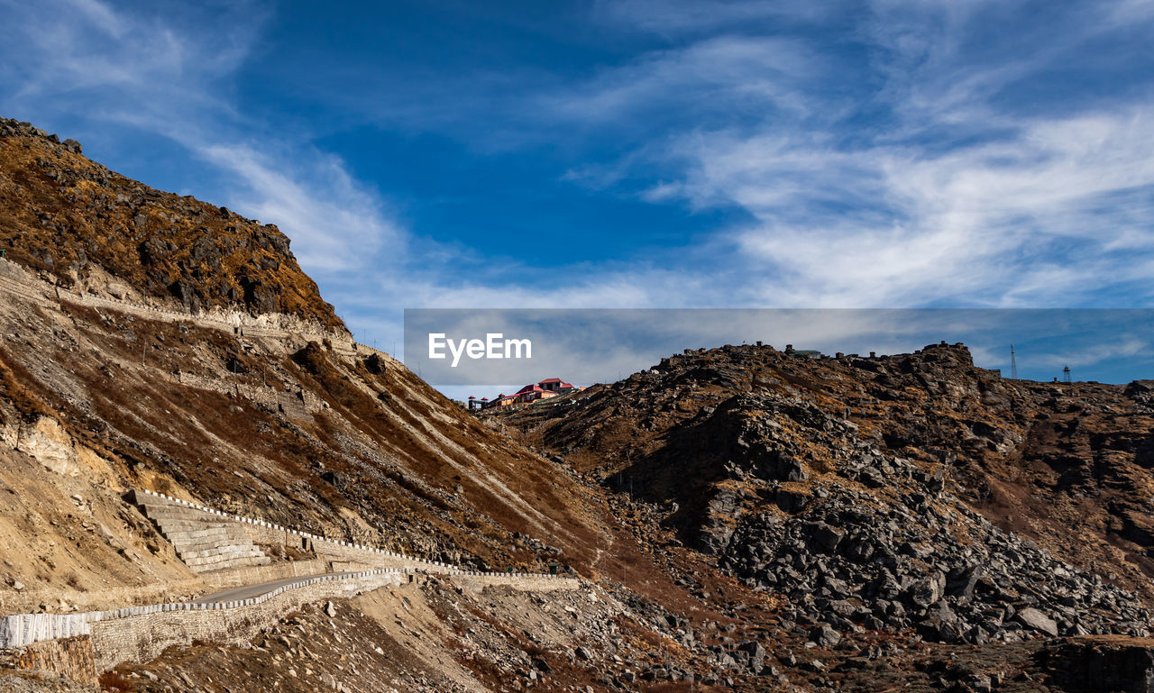 Himalayan breathtaking landscape with bright blue sky and twisty adventurous valley road