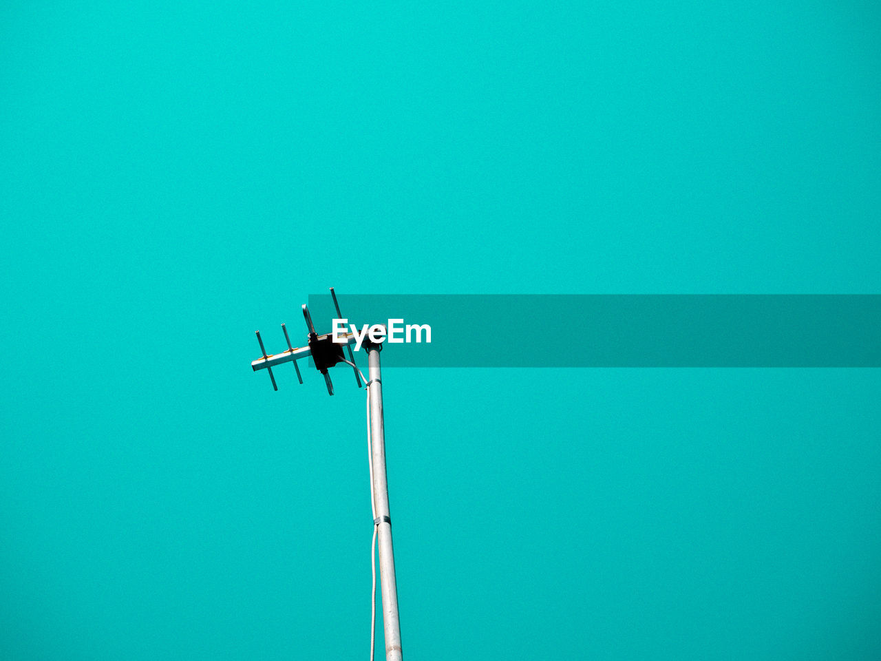 Low angle view of floodlight against blue sky