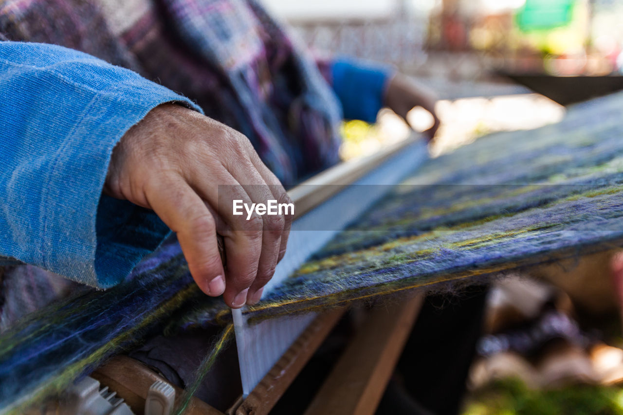 Midsection of man working on wood