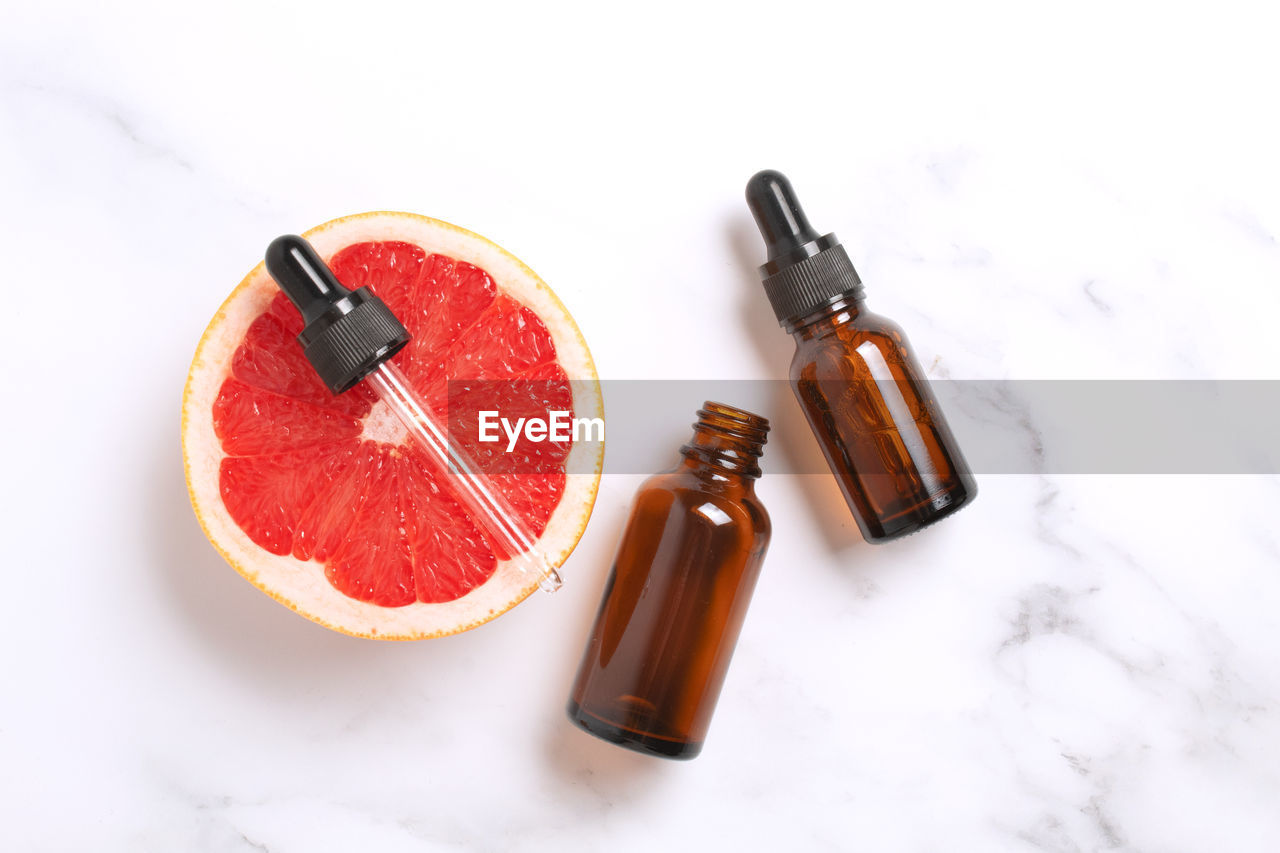 food and drink, food, bottle, drink, fruit, no people, healthy eating, produce, studio shot, orange, container, white background, high angle view, indoors, soft drink, refreshment, wellbeing, red, plant, alcoholic beverage, freshness