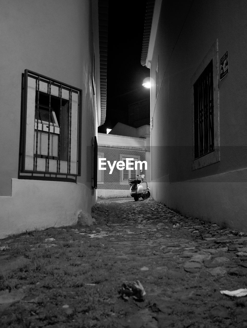 Street amidst buildings in city at night