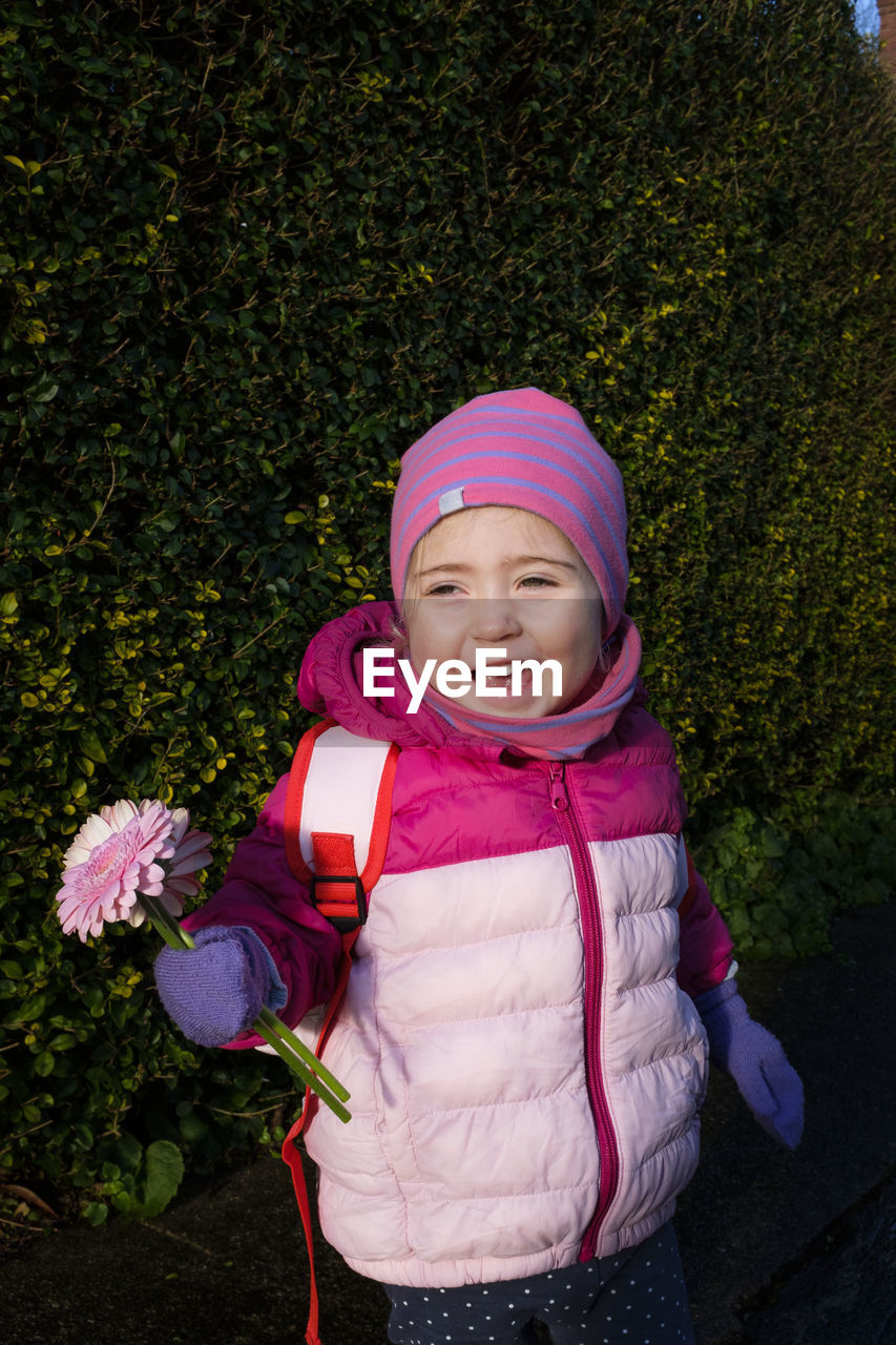 PORTRAIT OF SMILING GIRL WITH PINK HAT