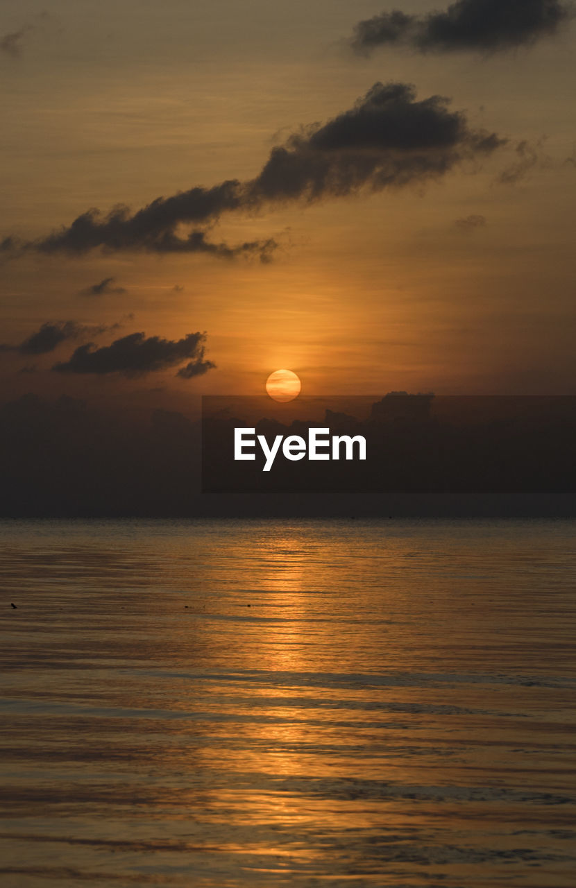 Scenic view of sea against romantic sky at sunset