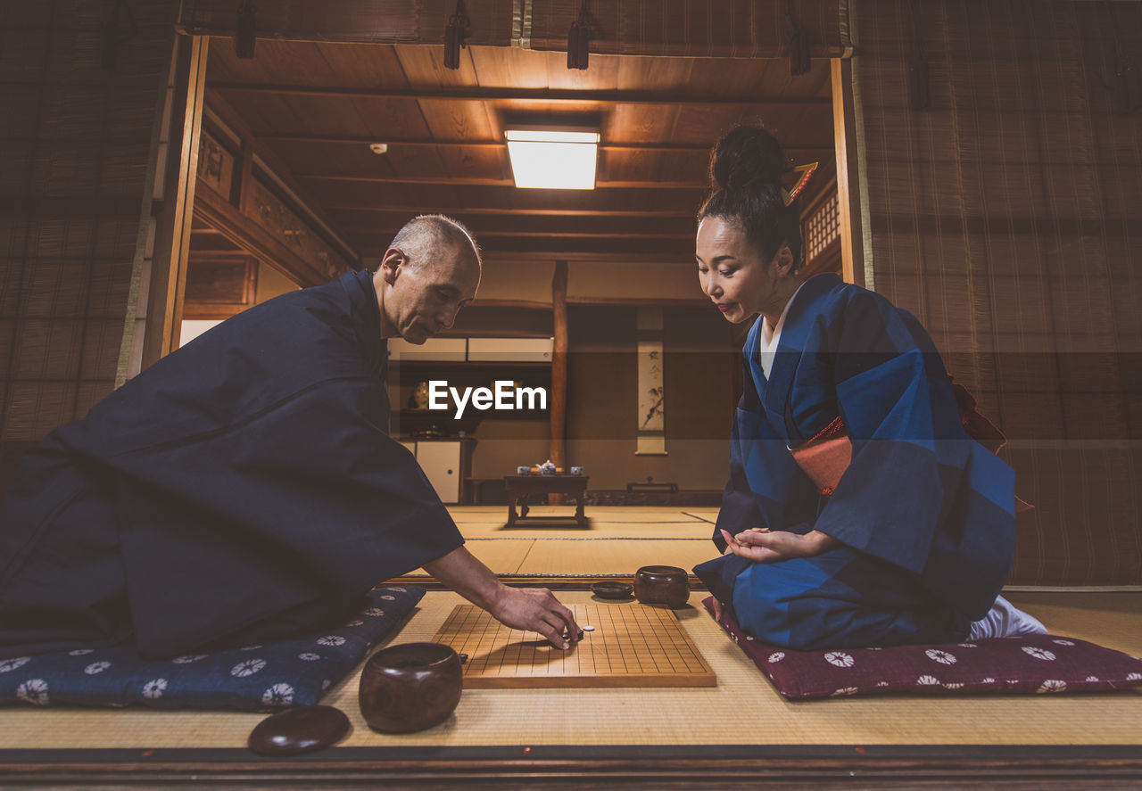 Side view of couple sitting at home