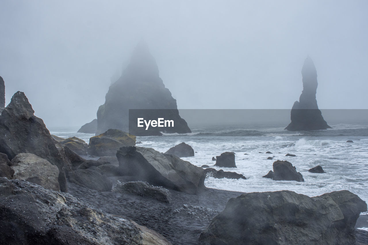 sea, water, rock, land, sky, beauty in nature, beach, coast, scenics - nature, nature, environment, ocean, fog, landscape, travel destinations, wave, no people, travel, rock formation, outdoors, terrain, cloud, coastline, cliff, tranquility, seascape, bay, motion