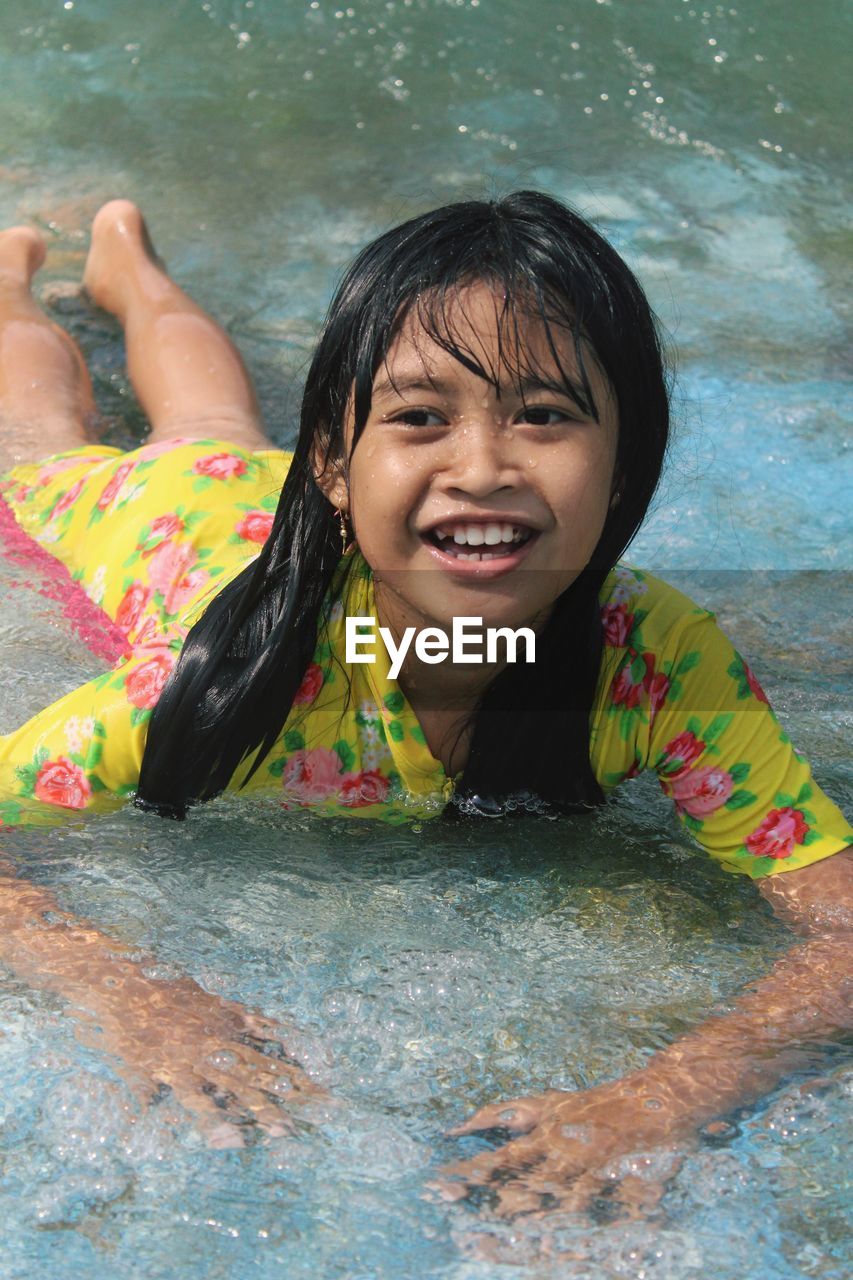 Portrait of smiling girl in swimming pool