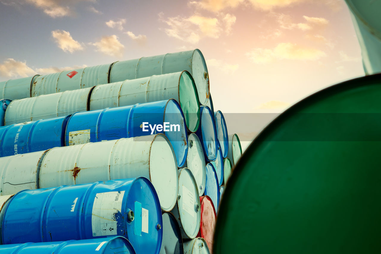 Old chemical barrels stack. red, green, and blue chemical drum. steel tank of flammable liquid. 