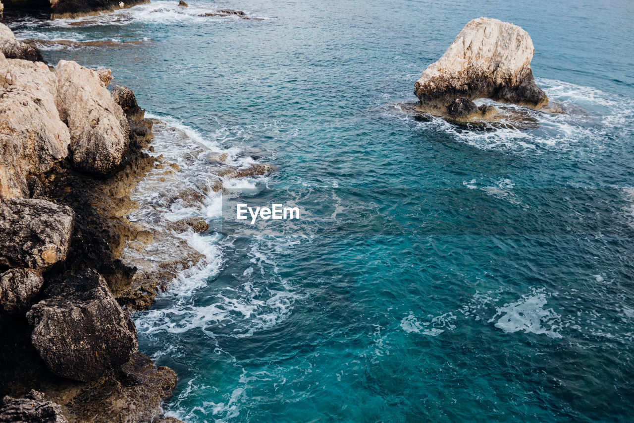 High angle view of rock formations in sea