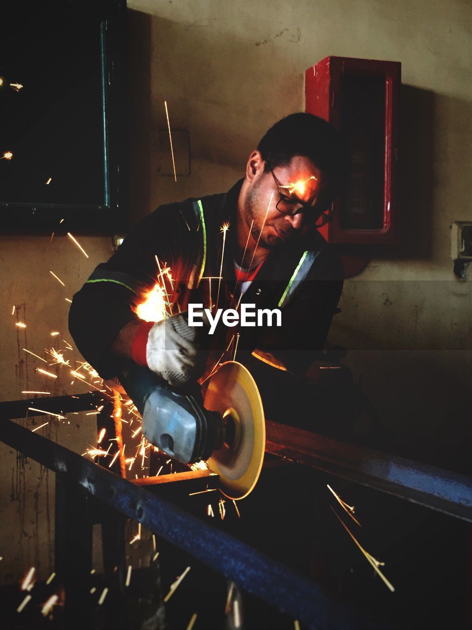 Worker welding at workshop