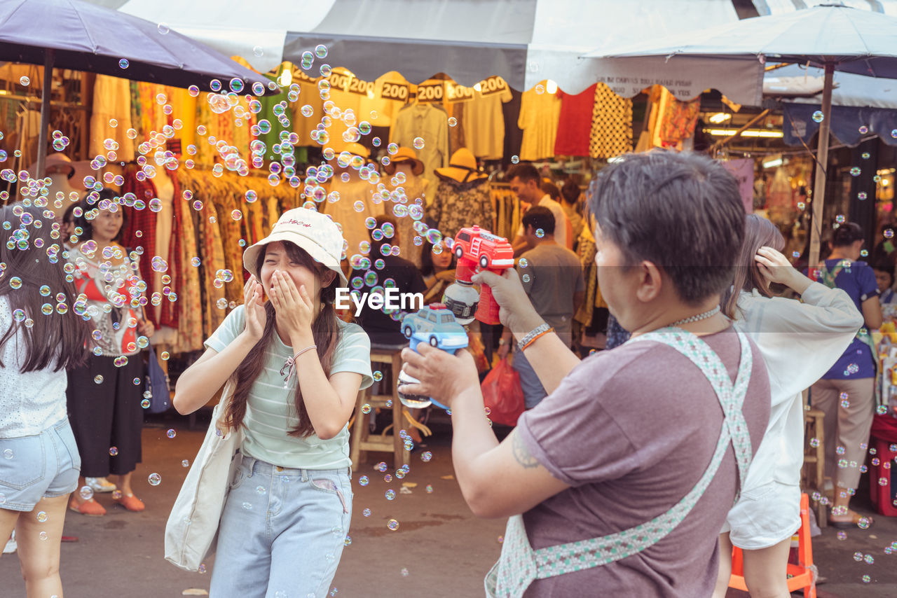 PEOPLE PHOTOGRAPHING AT MARKET