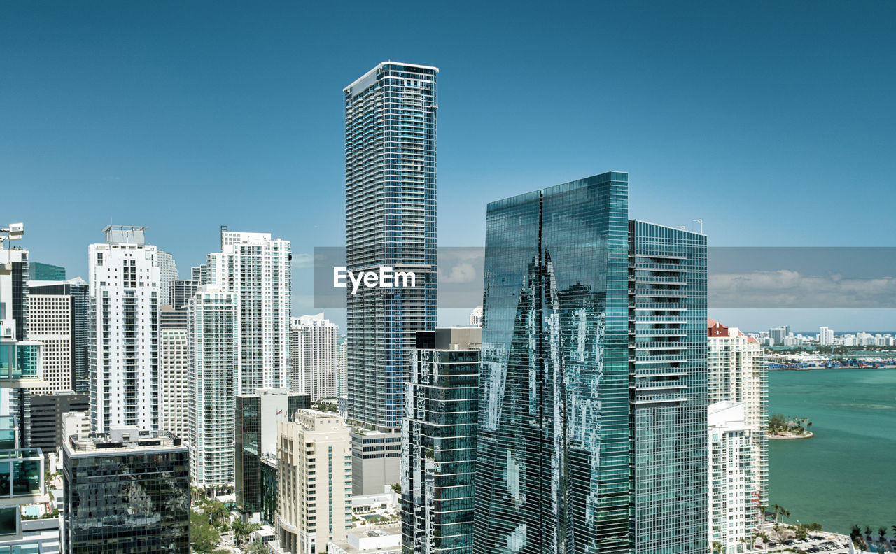 Modern buildings in city against clear sky