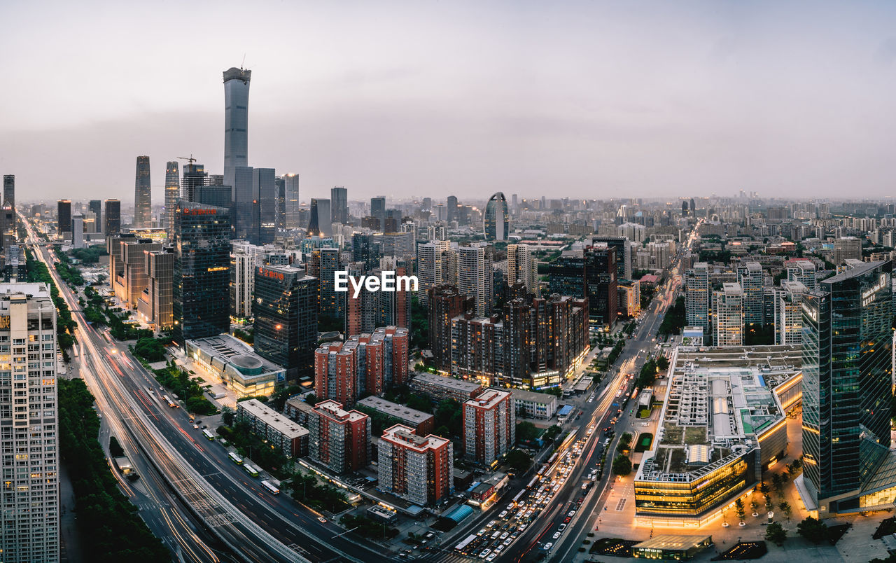 AERIAL VIEW OF BUILDINGS IN CITY AGAINST SKY